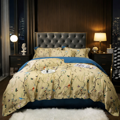 Bedroom with a bed featuring a floral comforter and blue blanket, nightstands with lamps, and cityscape view.